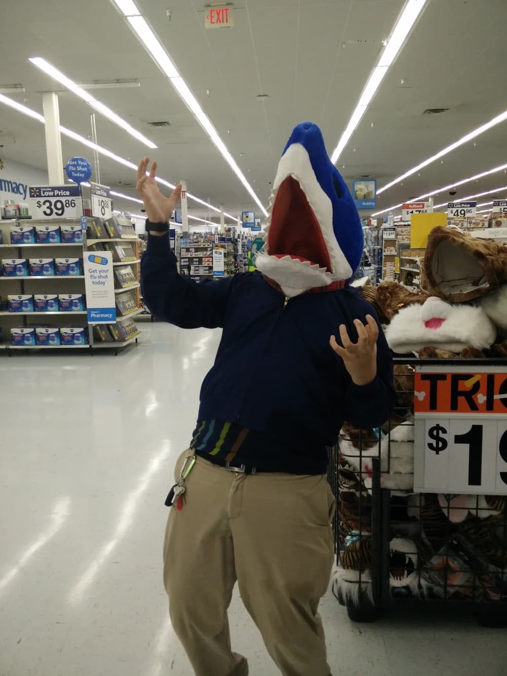 Darrel wearing an oversized shark head in a shop